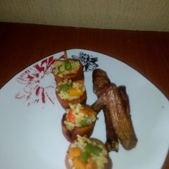 A picture of Fried rice in Skewed Plantain rings and fried Chicken.