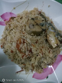 A picture of Jollof Rice and Iced Fish.