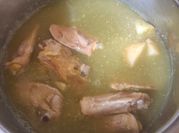 Una foto de muslos de pollo en salsa