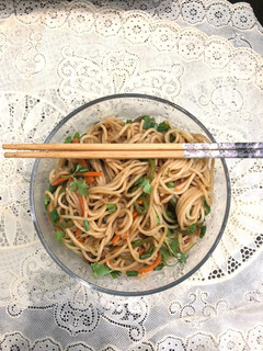 A picture of Chowmein with leftover Seekh Kebab.