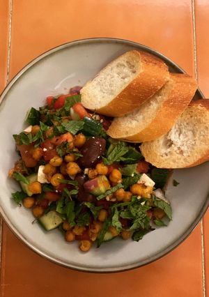 A picture of Greek Salad with fried Chickpeas.