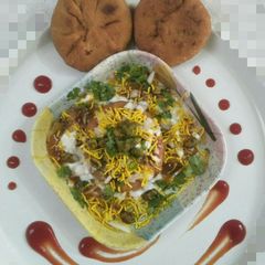 A picture of Poha pyaz ki kachori chat.