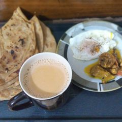 A picture of Achar Paratha With anda or garma garam Karak Chai.