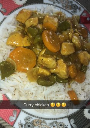 A picture of White rice and Curry chicken soup.