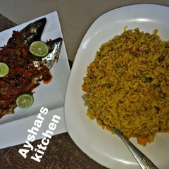 A picture of Simple jollof rice and griled fish.