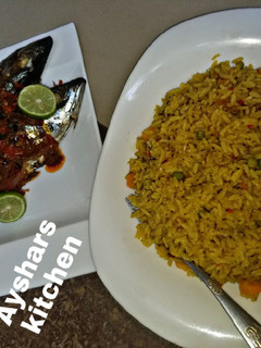 A picture of Simple jollof rice and griled fish.