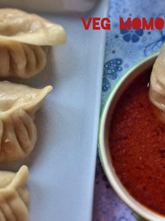 A picture of Vegetable Momos with Spicy Chilli Sauce.