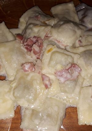 Una foto de Ravioles con salsa de crema y jamón crudo
