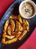 Baked Spiced potato wedges with garlic Bechamel sauce