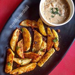 A picture of Baked Spiced potato wedges with garlic Bechamel sauce.