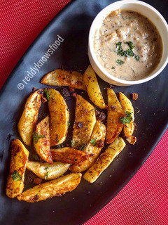 A picture of Baked Spiced potato wedges with garlic Bechamel sauce.