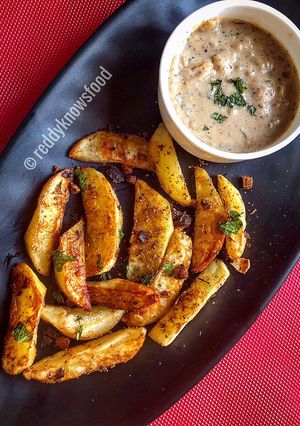 A picture of Baked Spiced potato wedges with garlic Bechamel sauce.