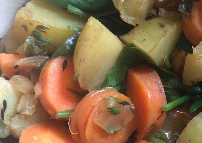 Vegetable curry with carrots, carrot tops, potatoes and spinach