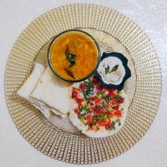 A picture of South Indian Thali-Uttapam, Neer Dosa, Sambhar, coconut chutney.