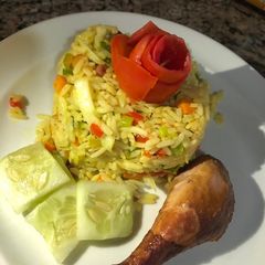 A picture of Fried rice and chicken.
