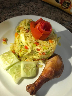 A picture of Fried rice and chicken.
