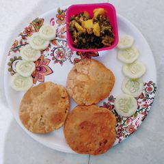 A picture of Tomato puri with mix veg.