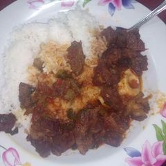 A picture of Beef stew with rice.