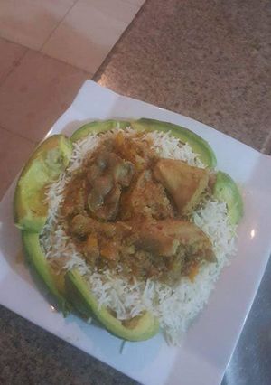 A picture of Basmati rice with avacado and tomato stew.
