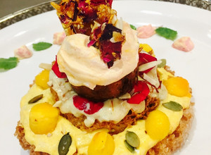 A picture of Ghewar cake with gulkand and mango rabdi mousse.