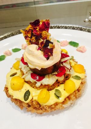 A picture of Ghewar cake with gulkand and mango rabdi mousse.