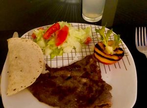 Una foto de Placeres en el Plato: Carne de Res, Ensalada de Durazno y Quesadillas de Frijoles" 🍖🍑🧀