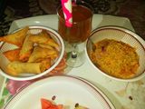 Indomie, spring rolls and samosa, fruit and special drink
