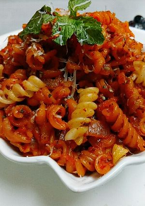 A picture of Cheesey spiral Pasta in red sauce.