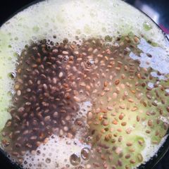 A picture of Cucumber juice with sabja seeds.