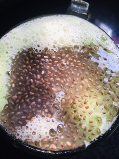 A picture of Cucumber juice with sabja seeds.