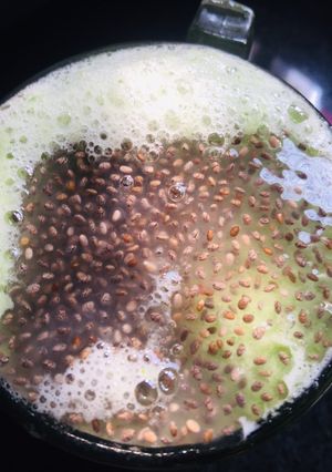A picture of Cucumber juice with sabja seeds.