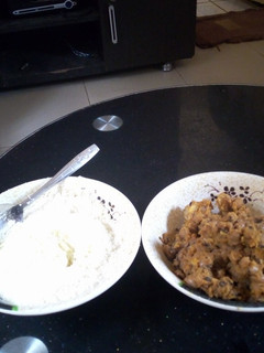 A picture of Plantain and beans porriage with garri and milk.