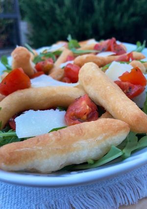 A picture of Fried Focaccia Sticks with Arugula and Cherry Tomatoes.