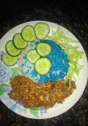 A picture of Blue rice with fish source.