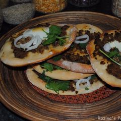 A picture of Pizza with minced beef and egg.
