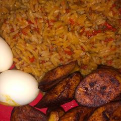 A picture of Jollof rice, boiled egg and dodo.