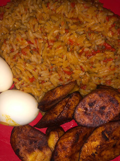 A picture of Jollof rice, boiled egg and dodo.