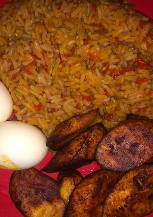 A picture of Jollof rice, boiled egg and dodo.