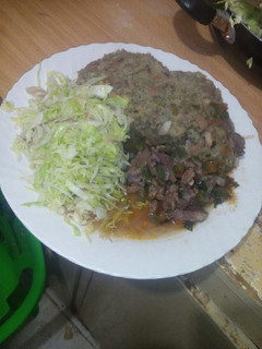 A picture of Mashed githeri with meat stew and steamed cabbage.