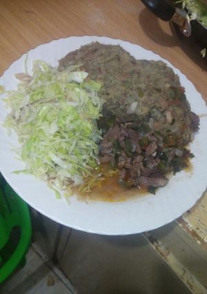 A picture of Mashed githeri with meat stew and steamed cabbage.