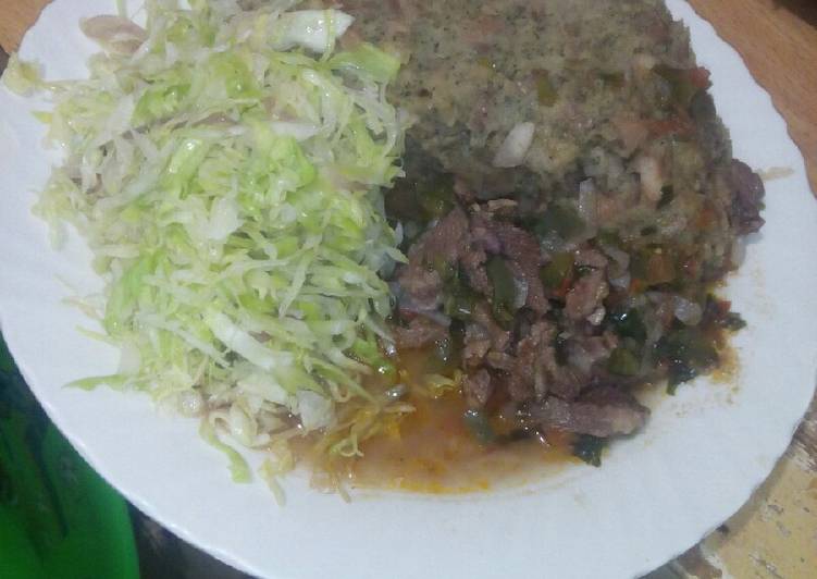Mashed githeri with meat stew and steamed cabbage