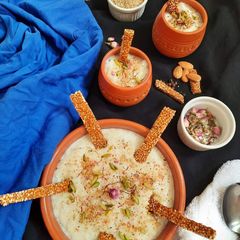 A picture of Thandai kheer served with Thandai flavoured Sesame Chikki.