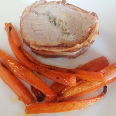 A picture of Stuffed pork fillet with roasted carrots.