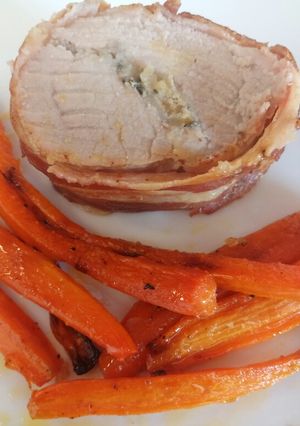 A picture of Stuffed pork fillet with roasted carrots.