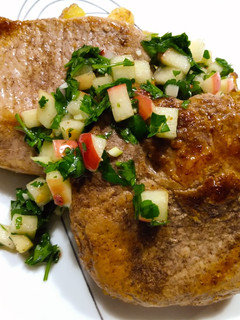 A picture of Allspice pork chops with apple chimichurri.