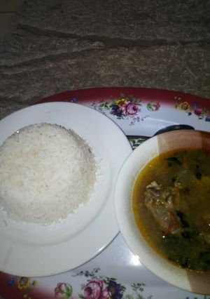 A picture of White Rice with Goat meat and Assorted Pepper Soup.