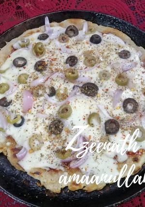 A picture of Tawa Veg Pizza with Olives.