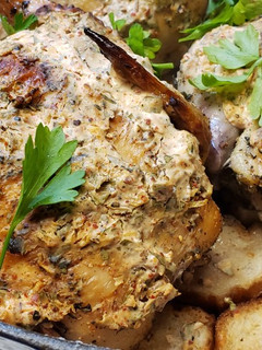 A picture of Roasted Cornish Hens over French Breads with a Rich Creamy Top.