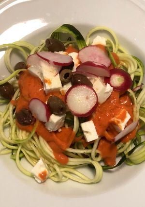 A picture of Zucchini Spaghetti with Tomato Sauce, Kalamata Olives, Feta, and Radishes.