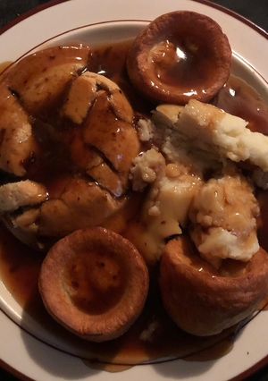 A picture of Steak Pie, Mash, Yorkshire Puddings and Gravy.
